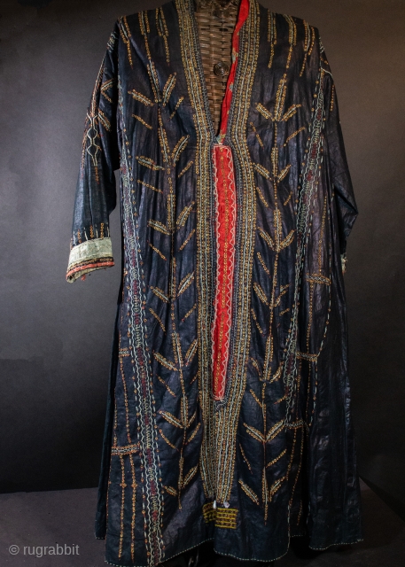Yemen dress with coral beads, cowrie shells and mother of pearl amulets sewn on the dress. Metal sequins sewn in a tree of life motif on pounded indigo dyed cotton with a  ...
