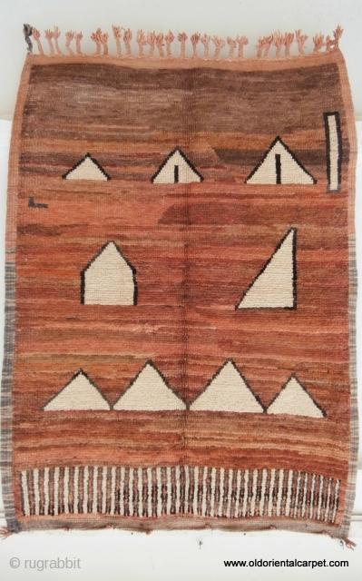 MOROCCAN BERBER MIDDLE ATLAS RUG. An unusual example from the region of Mrirt displaying the various shades of browns in lines across the field which is typical of their work. The weaver  ...