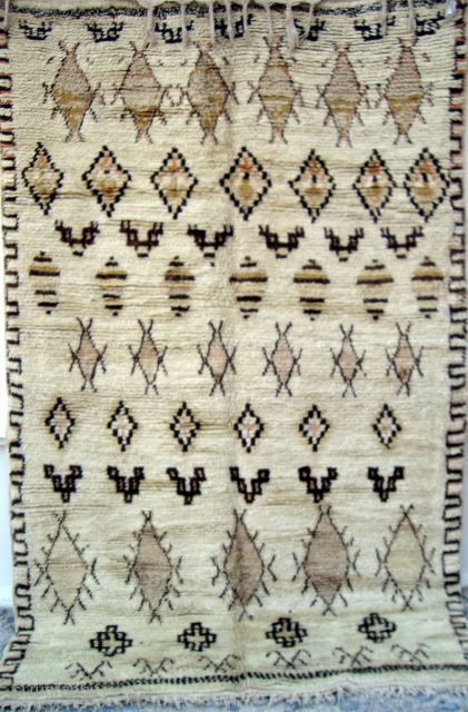 MOROCCAN MIDDLE ATLAS BERBER RUG which falls under the Beni Ourain group and is probably the work of the Ait Youssi tribe. It has silky undyed wool and delicate highlights of most  ...
