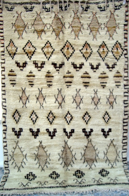 MOROCCAN MIDDLE ATLAS BERBER RUG which falls under the Beni Ourain group and is probably the work of the Ait Youssi tribe. It has silky undyed wool and delicate highlights of most  ...