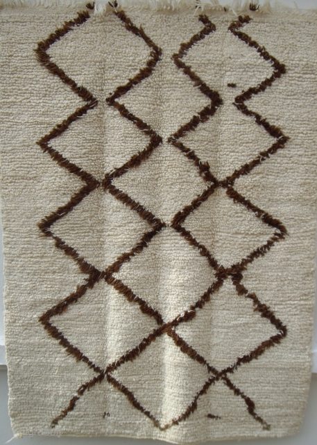 MOROCCAN HIGH ATLAS BERBER RUG. An unusual example where the pile has been woven with looped knots. The wools are soft and lustrous and the design is of dark brown undyed wool.  ...