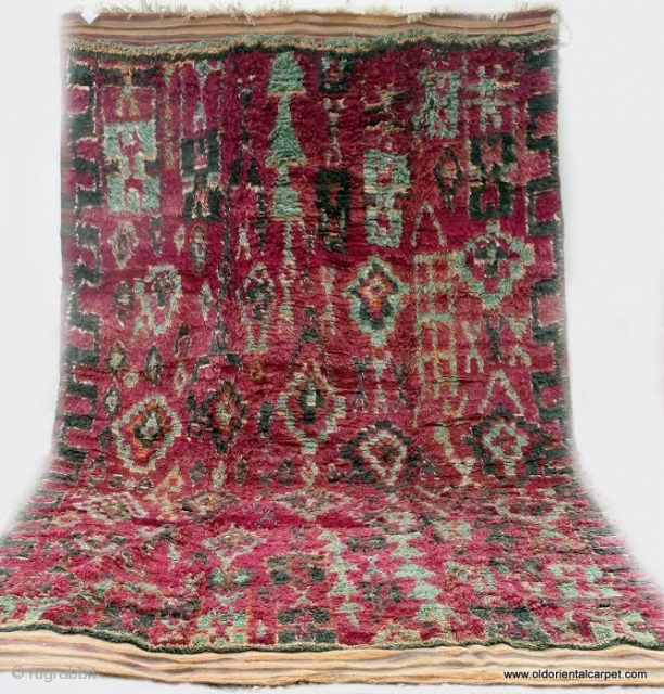 MOROCCAN BERBER HIGH ATLAS CARPET. An old and rare carpet from the Berbers of Ait bou Ichaouen in the eastern High Atlas near the border with Algeria. Weaving in this remote area  ...