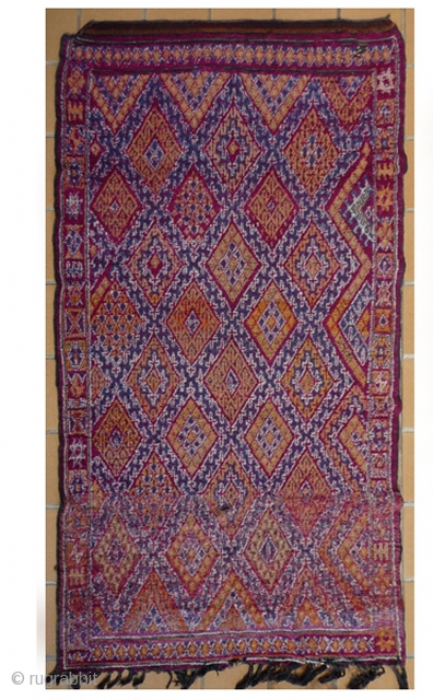 MOROCCAN MIDDLE ATLAS BERBER CARPET. The rich vibrant colors are typical of work from the Beni MGuild. The pile is long, and the piece is in excellent condition. Ref. 2144. Size 283x126  ...