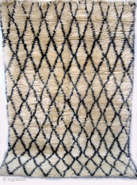 MOROCCAN BERBER BENI OURAIN RUG in which the warps, wefts and sumptuous long, silky knotted pile are all of hand spun undyed Berber wools. The simple lattice design is very pleasing. The  ...