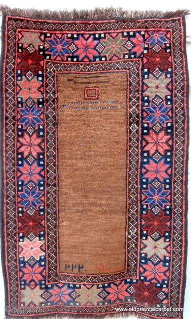 RARE AFGHAN PRAYER RUG. The contents of the field make this an extraordinary and rare piece. At the top there are depictions of two pendants known as "tumar". These are sometimes attached  ...