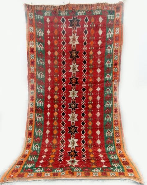 Long camel train depicted in this rare High Atlas rug from the Ait Douchen Berbers. The village uses an abandoned riyad as a center for weaving needs such as tools, looms, wools,  ...