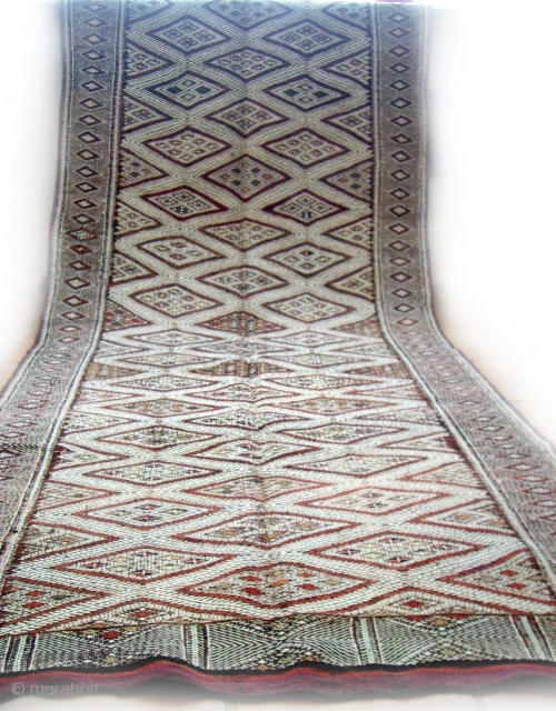 MOROCCAN BERBER MIDDLE ATLAS FLAT WEAVE/KILIM. An old beautifully embroidered `hanbel`or cover from the Ait Arfur Berber group in the Middle Atlas. The intricate white designs are created by the use of  ...