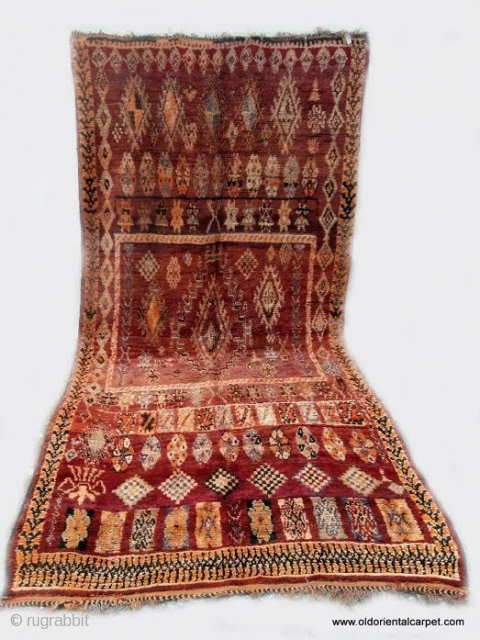 MORROCAN BERBER MIDDLE ATLAS CARPET. A large carpet from the region of Boujad which, unusually for this origin, has a well balanced overall design in which chestnut shades predominate. Other colours are  ...