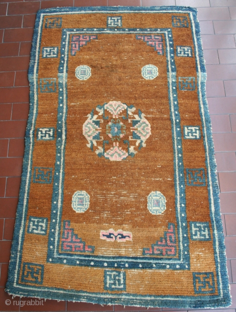 Here's a small, honest Tibetan khaden: nice tobacco color with good abrash, circa 119 x 67 cm, no repairs. An asymmetric benevolent cloud marks the sitting point, where pile is low as  ...