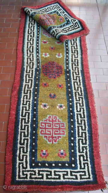 Very old big knot Tibetan "runner", 228 x 66 cm, narrow XIX century type, rare green field, bright colors, heavy w&w wool structure, hand-spun wool, very good condition, no repair.   