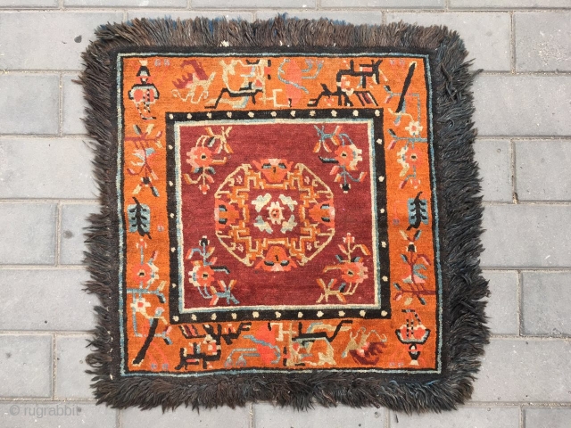 Out of the trunk of a monastery comes this perfect Tibetan square mat, a high rank lama individual seat in extraordinary mint condition, unused, no repairs, excellent wool with typical monastic colors,  ...