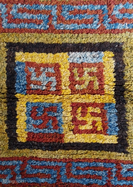 Old Tibetan Wangden rug, large khagangma square size (circa 90 by 90 cm) for monastic use, powerful five swastikas design, genuine and excellent condition, no repairs. More photos on request.   