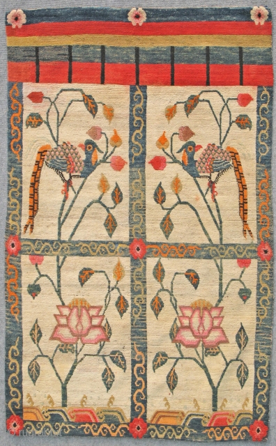 Tibetan door curtain rug. Early 20th Century. Natural and aniline dyes. Rare type of rug and rare design of peacocks in the two top windows and lotus flowers in lower ones.  