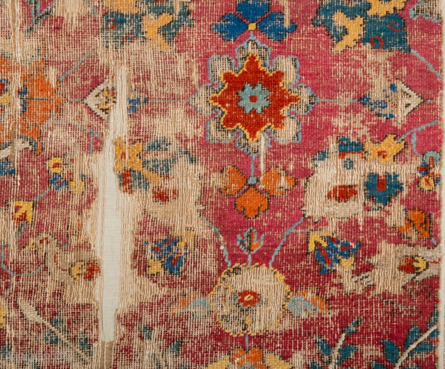 Persia Mid 17th Century Khorasan or Esfahan Rug Fragment.A fragment of a carpet woven in the court workshops of Esfahan. The primary design consists Lovely red while further spiralling vines decorated with  ...