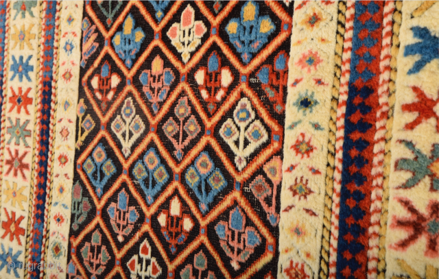 A small-format Kuba with a rare design. A repeat of flowers arranged into rows is seen in the dark brown field.19th Century Shirvan Kuba Rug The white-ground main border contains large star-shaped  ...