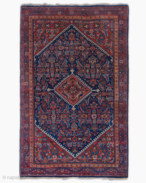 Period: Early 20th Century
Origin: Iran
Dimensions: 130 x 225 cm

This rare early 20th century Persian Mahal rug highlights a powerful and rhythmic floral composition featuring a nested diamond medallion structure anchored within a  ...