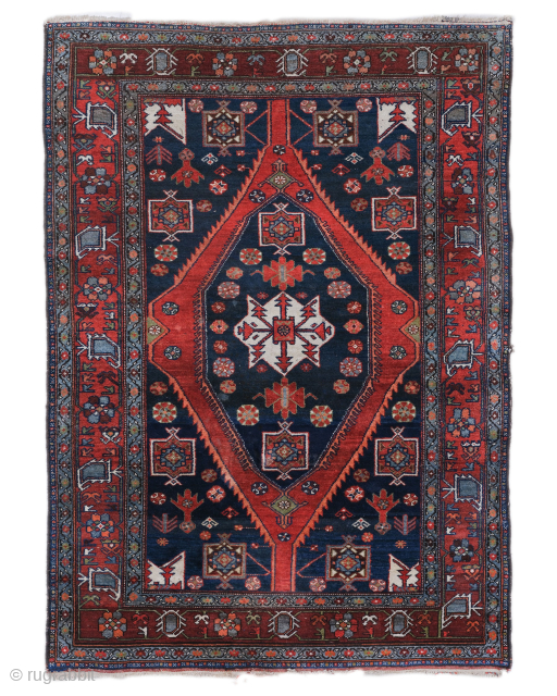 Period: Early 20th Century
Origin: Heriz, Northwest Iran
Dimensions: 143 x 200 cm

This rare early 20th century Persian Heriz rug highlights a powerful and rhythmic geometric composition featuring a monumental, double layered diamond medallion  ...