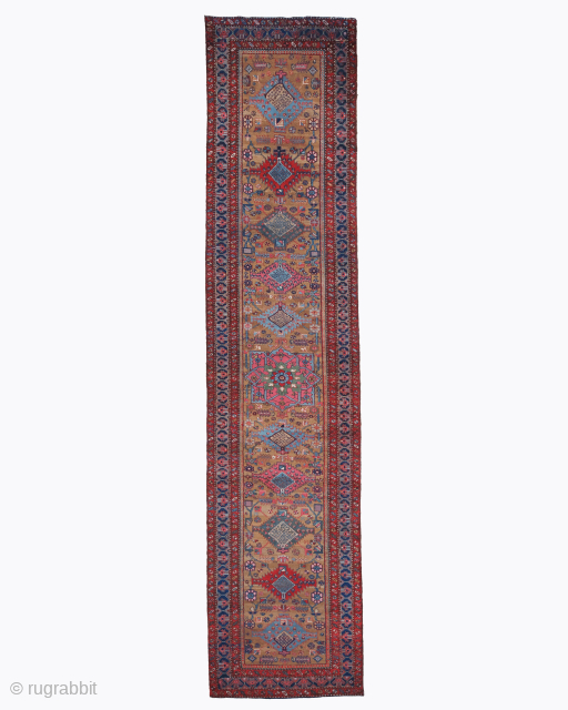 Period: Late 19th Century
Origin: Heriz, Iran
Dimensions: 90 x 426 cm

This magnificent Persian Serapi carpet, dating to the late 19th century, is a premier example of the bold, geometric artistry from the Heriz  ...