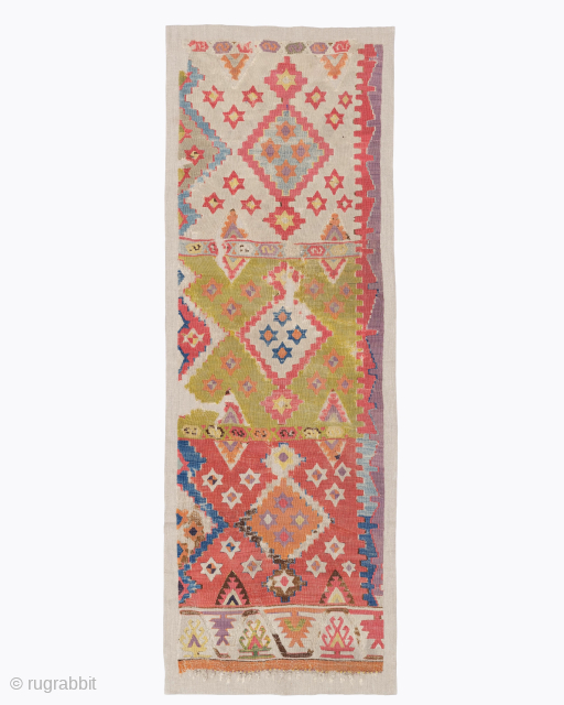 Period: 18th Century
Origin: West Anatolia
Dimensions: 194 x 63 cm

This rare 18th century West Anatolian kilim fragment highlights a powerful and rhythmic tribal composition featuring a vibrant multi paneled field decorated with archaic  ...