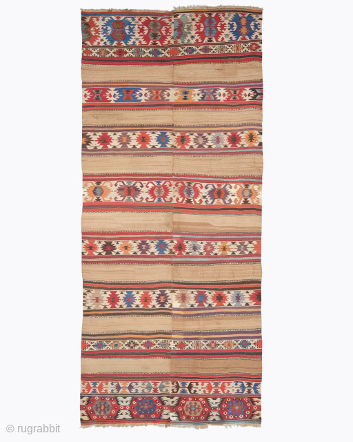 Period: 18th Century
Origin: Cappadocia, Central Anatolia
Dimensions: 370 x 165 cm

This rare 18th century Cappadocia kilim highlights a powerful and rhythmic tribal composition featuring a series of horizontal decorative bands anchored within an  ...