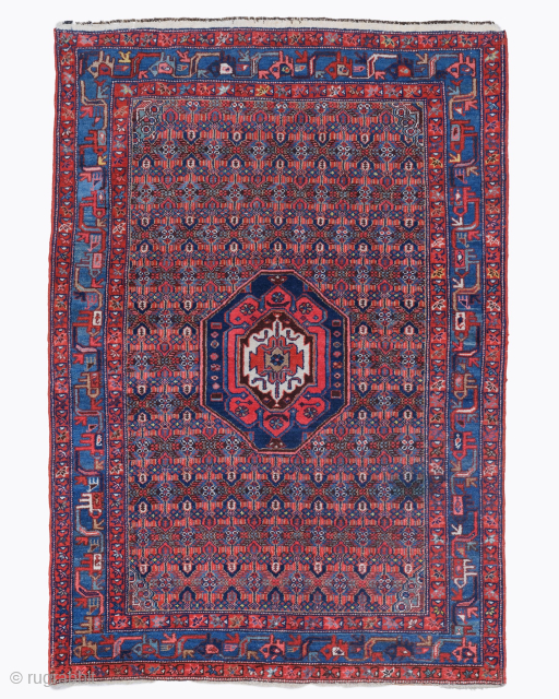 Period: Late 19th Century
Origin: Iran
Dimensions: 130 x 190 cm
This rare late 19th century Persian Hamadan rug highlights a powerful and rhythmic geometric composition featuring a centralized hexagonal medallion anchored within a densely ...