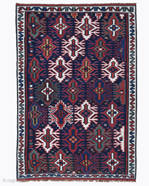 Period: Late 19th Century
Origin: Caucasus
Dimensions: 180 x 260 cm

This rare late 19th century Caucasian Kazak kilim highlights a powerful and rhythmic tribal composition featuring a dense arrangement of monumental “Lesghi star” or  ...