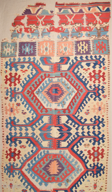 This impressive white-ground kilim is a weaving of the Hotamis Turkmen of the Konya region. It is woven in one piece, so unlike the two-panel kilims of this group there is no  ...