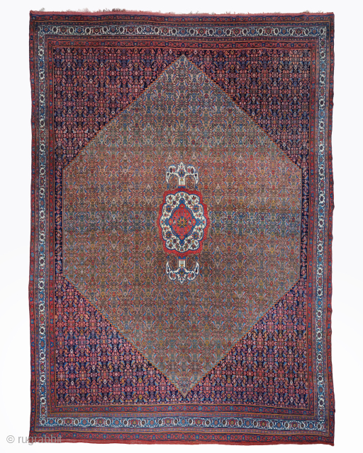 Period: Late 19th Century
Origin: Bidjar
Dimensions: 400 x 560 cm

This rare late 19th century Persian Bidjar carpet highlights a powerful and rhythmic floral composition featuring an expansive multi layered diamond medallion anchored within  ...