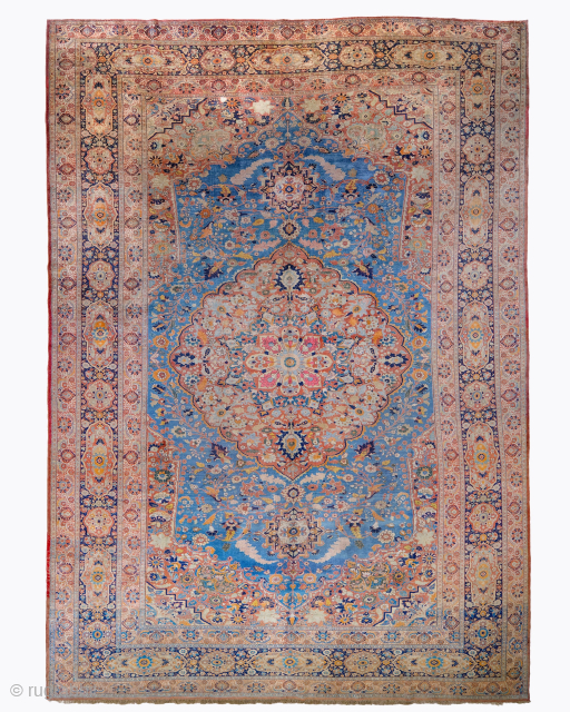 Period: 19th Century
Origin: Tabriz
Dimensions: 270 x 390 cm
This rare 19th century Persian silk Tabriz carpet highlights a powerful and rhythmic floral composition featuring a luminous sky-blue field dominated by a monumental, multi-layered ...