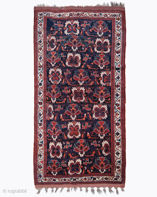 Period: Late 19th Century
Origin: Afshar
Dimensions: 165 x 315 cm

This rare late 19th century Persian Afshar rug highlights a powerful and rhythmic floral composition featuring a vertical sequence of stylized botanical blossoms anchored  ...