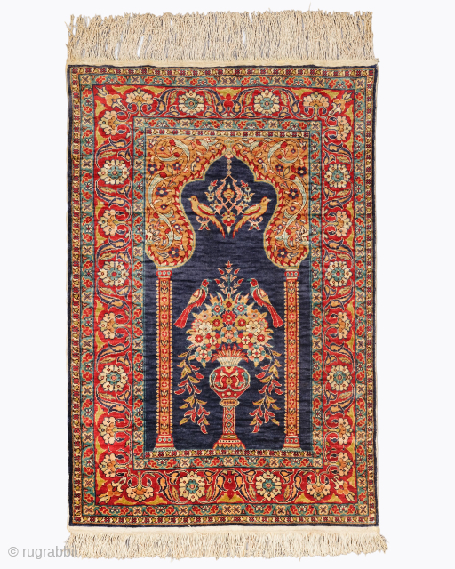 Period: Mid 20th Century
Origin: Kayseri
Dimensions: 70 x 107 cm

This rare mid 20th century Kayseri silk prayer rug highlights a powerful and rhythmic floral composition featuring a centralized flower vase motif anchored within  ...