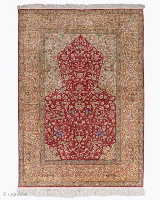 Period: Mid 20th Century
Origin: Kayseri
Dİmensions: 128 x 182 cm

This rare mid 20th century Kayseri silk prayer rug highlights a powerful and rhythmic floral composition featuring a vibrant madder red prayer niche anchored  ...