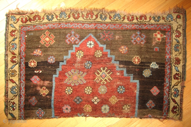 Fragment of old Kurdish weaving with captivating design of an archaic stepped arch form on a spare field, original selvages; 3rd quarter 19c; 3.5 feet Horiz. x 2.0 feet Vert. (104x61cm). Wonderful  ...