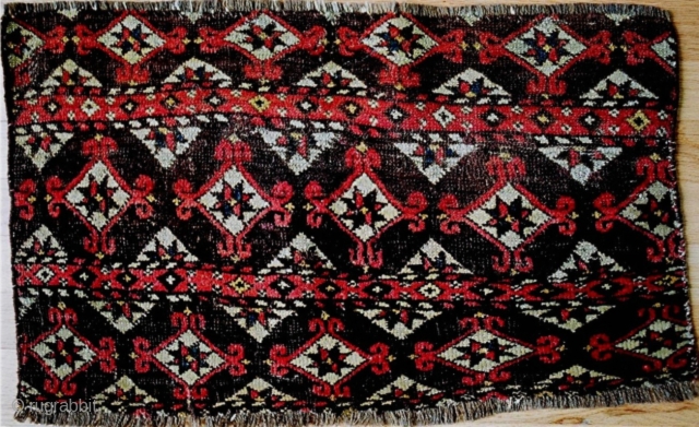 Fragment of early Chodor main carpet elem, 26x15 inches (66x38 cm). Wonderful vintage example with early pale yellow dye and an abundance of irregular knotting. 1800-50. The second image shows the back. 