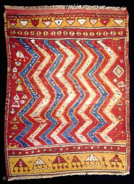 Unique Anatolian village rug, mid 19c, popularly called Konya, but probably woven in the Cappadocia region. The zig zag pattern imitates a familiar design in Ottoman textiles, particularly those used for funerary  ...