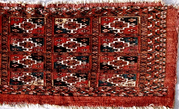 A choice Tekke torba with an unusual format of 4x5 aina gols, 12x36 inches, 31x92cm, excluding warp ends; c 1850 or before. Two colors of silk highlights, white cotton, dark indigo and  ...