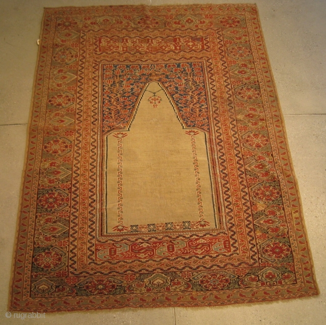 A mid-19th Century Ghiordes Prayer Rug, 5'5" x 4'0".  Great color with traditional pattern.  Reselvedged, flat-stitch repairs, and normal wear associated with rugs from this period.     