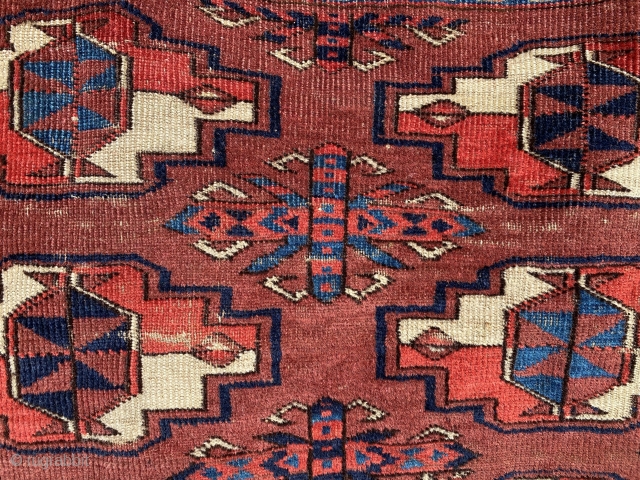 SOLD:Yomud chuval with spacious design, good age, and varied color. Asymmetric knotting, with some cotton plied with wool in the weft on the top of the piece. There are areas of wear  ...