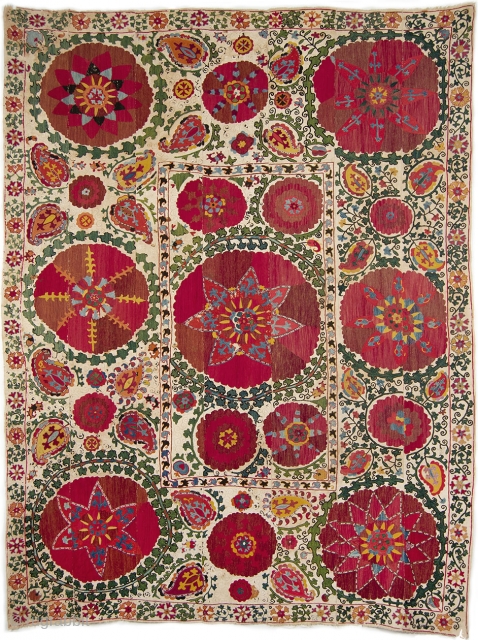 Bukhara Suzani, Uzbekistan, 19th C. Silk embroidery on cotton ground in chain stitches. Size: 7'10'' x 5'9'' (239 x 175 cm). Seven panels make up the cotton ground with the inner field  ...