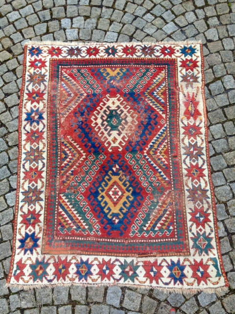 JUST AS FOUND! Beautiful and early Bordjalou rug, unfortunately with many bad repairs but due to its colors and rare white-grounded star border it still has lots of magic and character I  ...