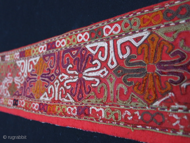 Turkmen Chodor silk embroidered costume fragment. Adras ikat backing. Circa 1900.
Size: 120 cm x 10 cm (47.2"x 3.9").               