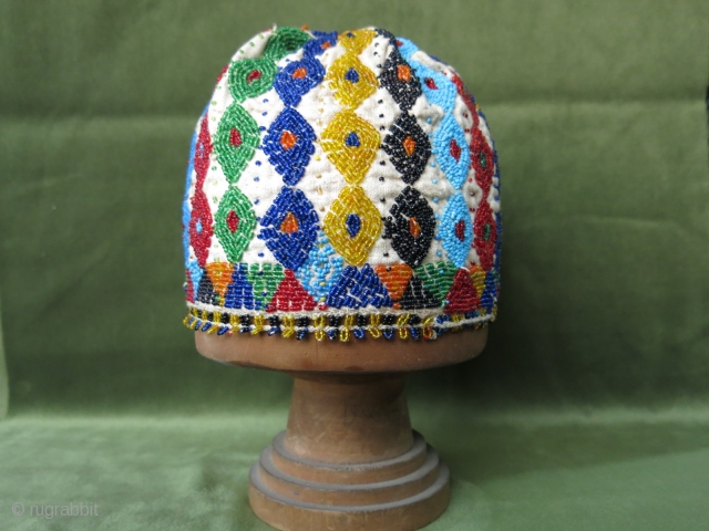 Turkish Kutahya region glass beaded and embroidered hat with tiny beaded tassels at the edges. Height: 14 cm (5.5") x 56 cm in diameter (22").        