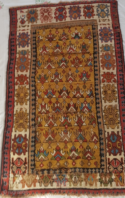 A very fragmented yellow ground antique caucasian rug cut in several parts but great colours approx 5ft x 3ft              