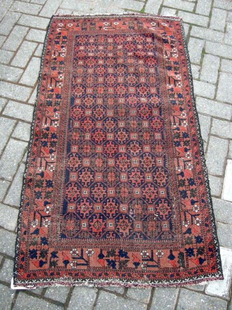 An antique belouch rug nice colours even corrosion and a few other issues as seen but a very pretty antique rug will clean well approx. 4ft9 x 2ft9.     