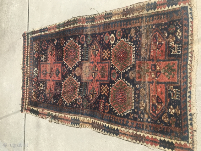 19th Century Kurdish rug with some damaged areas.                         