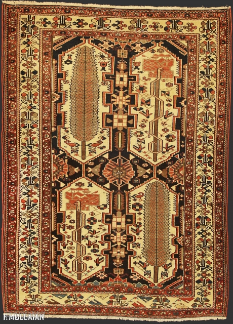 Antique Persian Bakhtiari Rug, ca. 1920,
192 × 142 cm (6' 3" × 4' 7"),

The deep indigo field with various angular floral motifs around four serrated and stepped, linked panels containing stylised trees.  ...