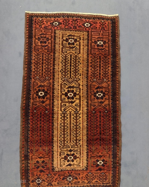 Beautiful Antique Persian Baluch Mashad Rug, 1880-1900
120 × 70 cm (3' 11" × 2' 3")

The light beige field with overall design of angular Hooke vine and lozenge palmettes. In broad light red  ...
