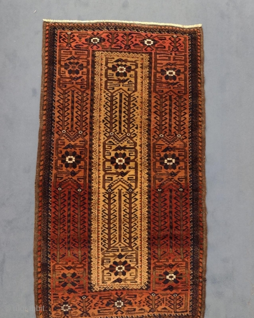 Beautiful Antique Persian Baluch Mashad Rug, 1880-1900
120 × 70 cm (3' 11" × 2' 3")

The light beige field with overall design of angular Hooke vine and lozenge palmettes. In broad light red  ...