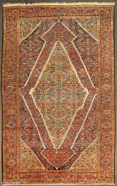 An antique Mahal carpet, West Persia, ca. 1900

The shaded indigo fiend with stylised polychrome herati design. Two rust-red and sandy-yellow large serrated medallions with similar design. Sandy-yellow herati spandrels. In rust red  ...