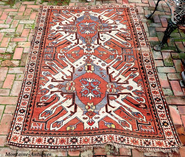Caucasian Eagle Kazak- approx. 5 x 7.8.  Two open field ivory/blue medallions with iconic Cheleberd/Sunburst motifs. Circa late 19th/early 20th cent. Pile is low but even with some iron oxidation. Imperfections  ...